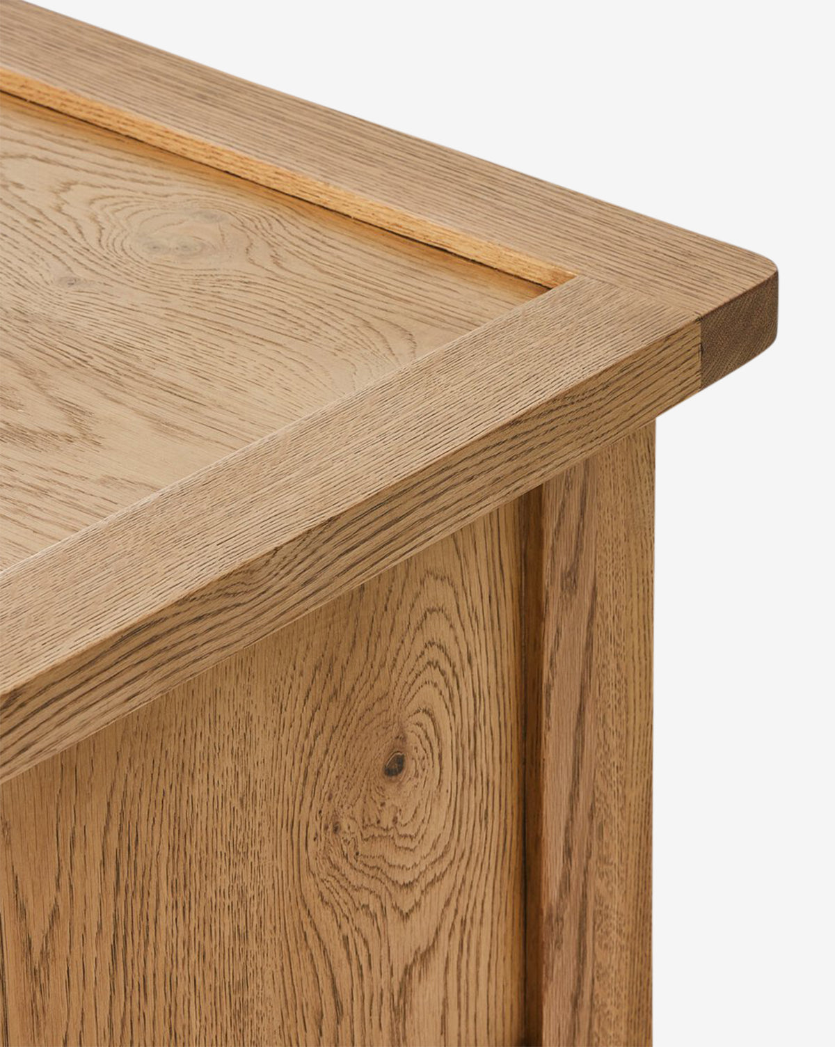 Close-up of the Faelan Nightstand corner, highlighting its light oak veneer with visible natural grain and knots and a sleek rectangular frame—ideal for elevating bedroom style, by McGee & Co.