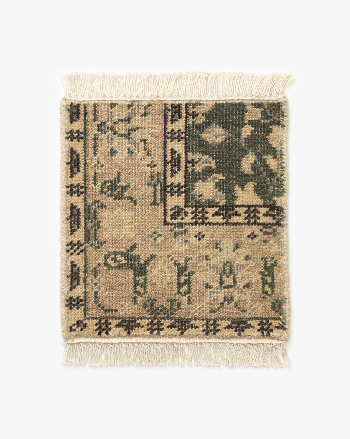 The Fernwood Hand-Knotted Rug Swatch is a small rectangular wool swatch with beige, green, and brown patterns, an intricate knotted design, decorative border, and fringe on the short ends by McGee & Co.