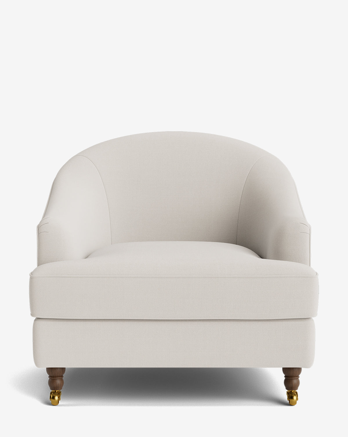 The Fletcher Lounge Chair is a spacious upholstered armchair with a curved back, rounded arms, wooden legs, and front brass casters in light beige fabric. Shown against a white background. Customizable fabrics available by McGee & Co.
