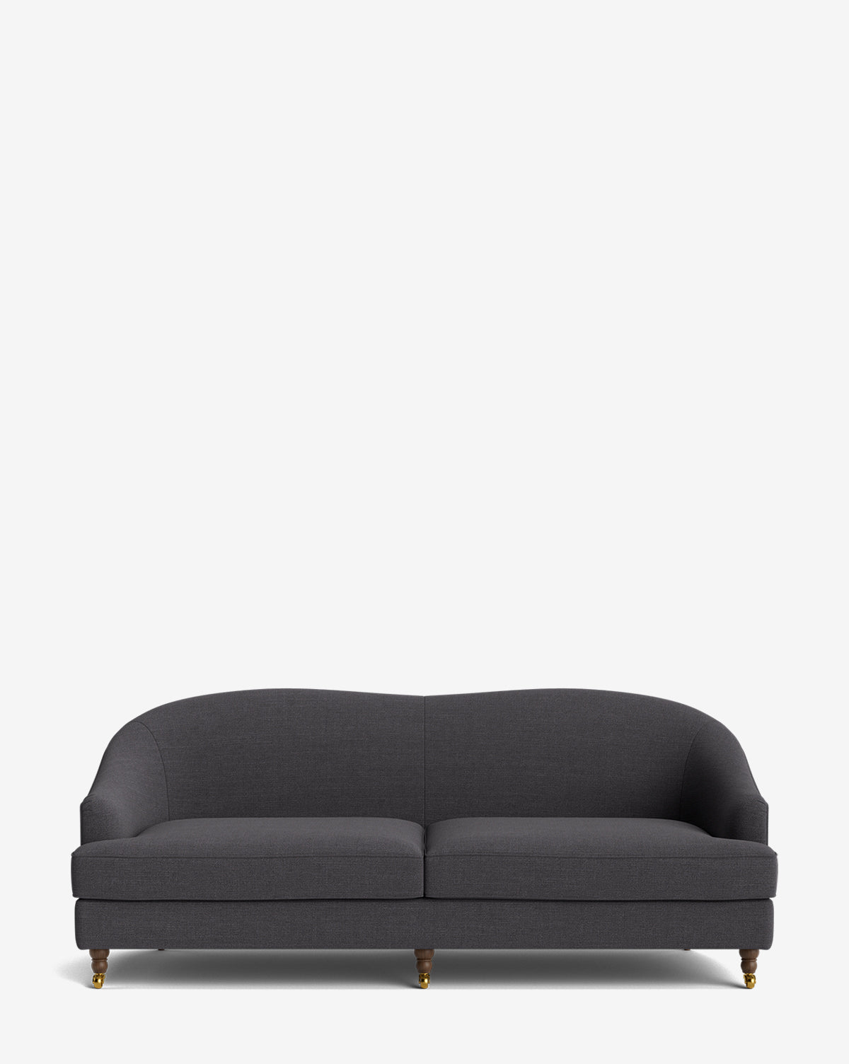 The Fletcher Sofa 76 is a modern, dark gray upholstered piece with a curved backrest, rounded arms, two seat cushions, and four short wooden legs with brass castors, shown against a plain white background by McGee & Co.