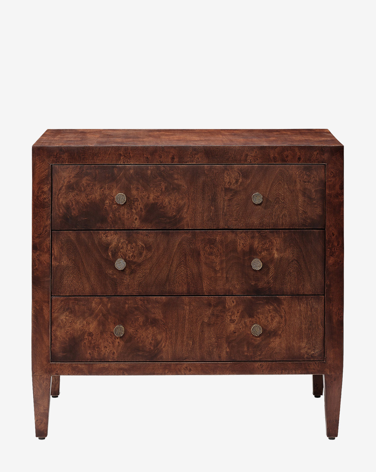 The Florana Nightstand is a wooden piece with a dark brown finish, three drawers with round metal knobs, and short legs. Its simple, rectangular design adds timeless style to any bedroom décor by McGee & Co.