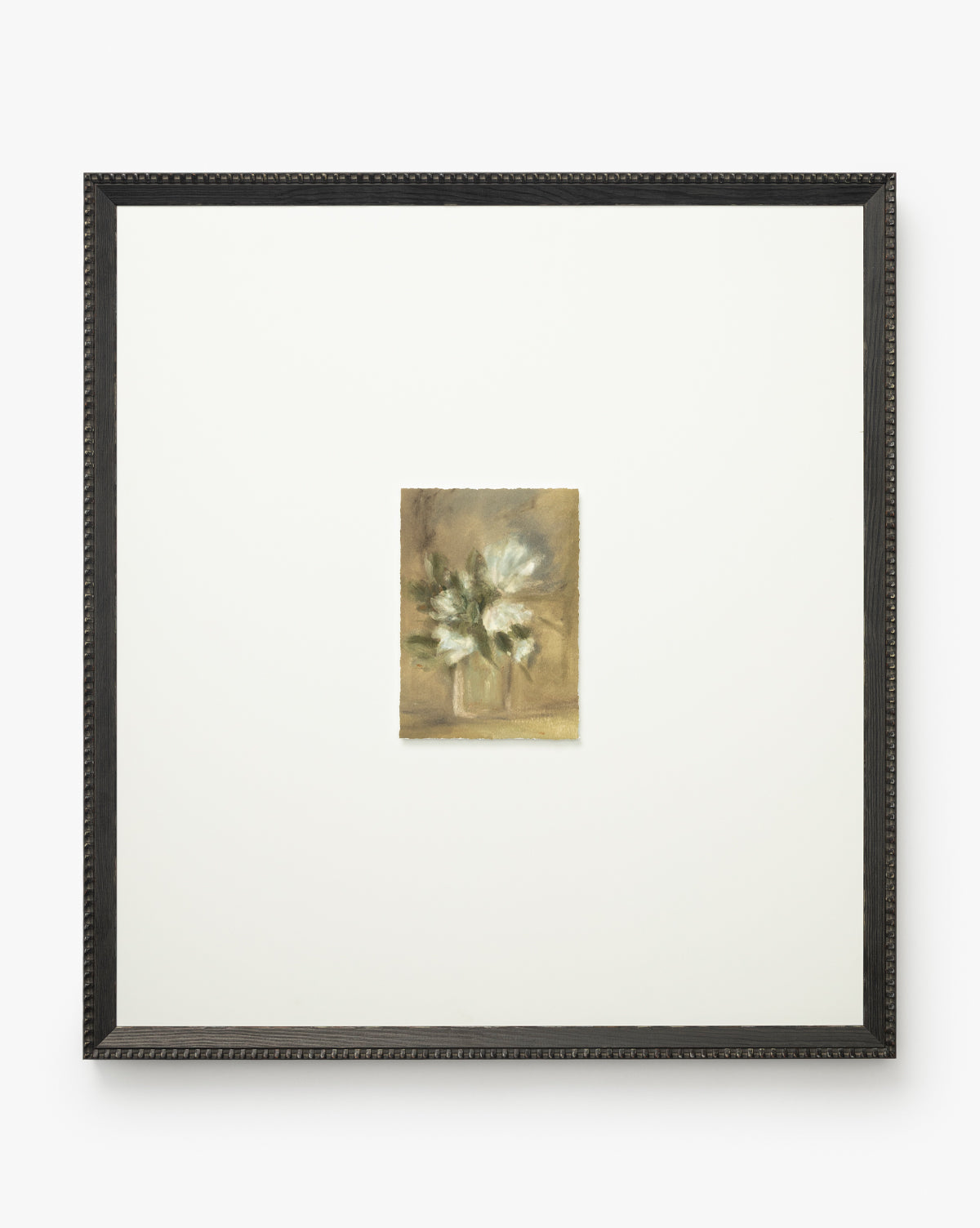 Flower Vase Still Life by Katie Mulder showcases a small painting of white flowers in a vase on a neutral background, set within a large white mat and dark wood frame. This elegant artwork is offered as a giclee print by McGee & Co.
