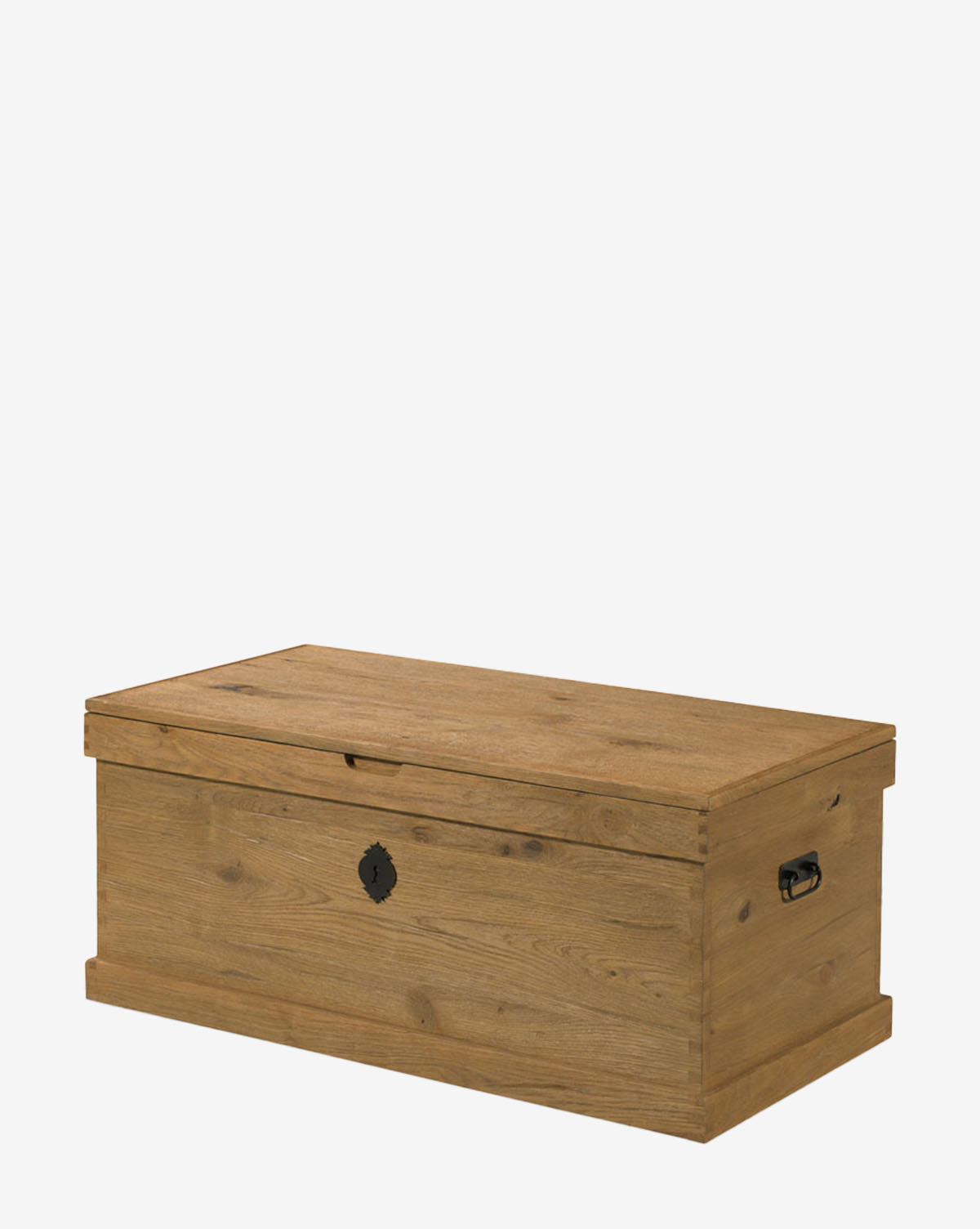 The Frances Trunk is a rectangular wooden storage piece with a natural oak veneer, hinged lid, metal side handles, and front keyhole, providing ample storage space against a plain white background by McGee & Co.