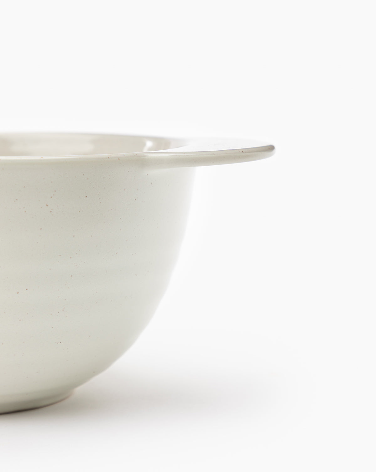 Close-up of the Fullmer Stoneware Batter Bowl with a handle, shown against a plain white background. Only half of the bowl is visible in the image, by McGee & Co.