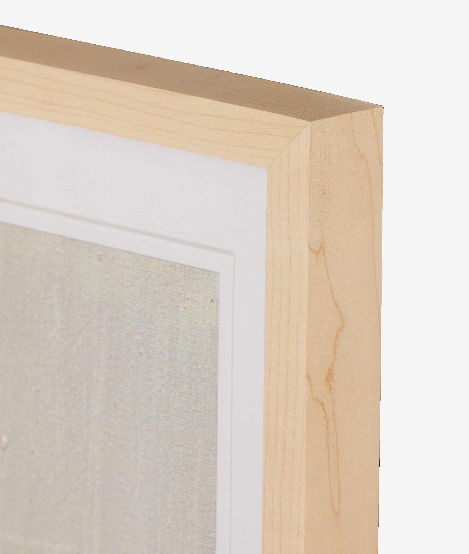 A close-up of the top right corner of a light-colored wooden frame with a white mat, displaying Galactic IX by Jade Dacay against a plain white background, by McGee & Co.