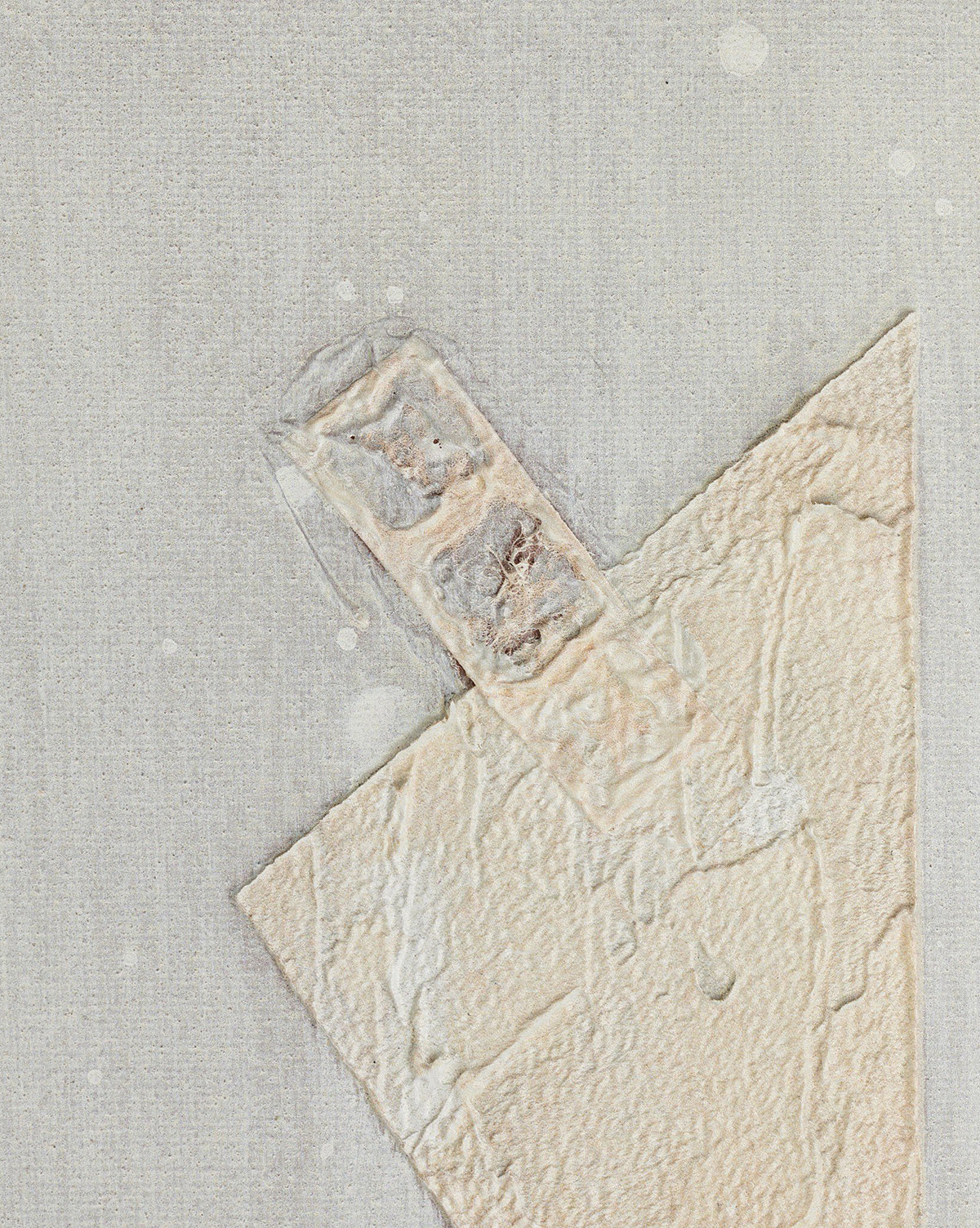 Galactic VII by Jade Dacay is a mixed media minimalist artwork featuring a textured, triangular off-white shape with a rectangular tab on a pale speckled background, enhanced by subtle patterns and set in a natural-toned frame, by McGee & Co.