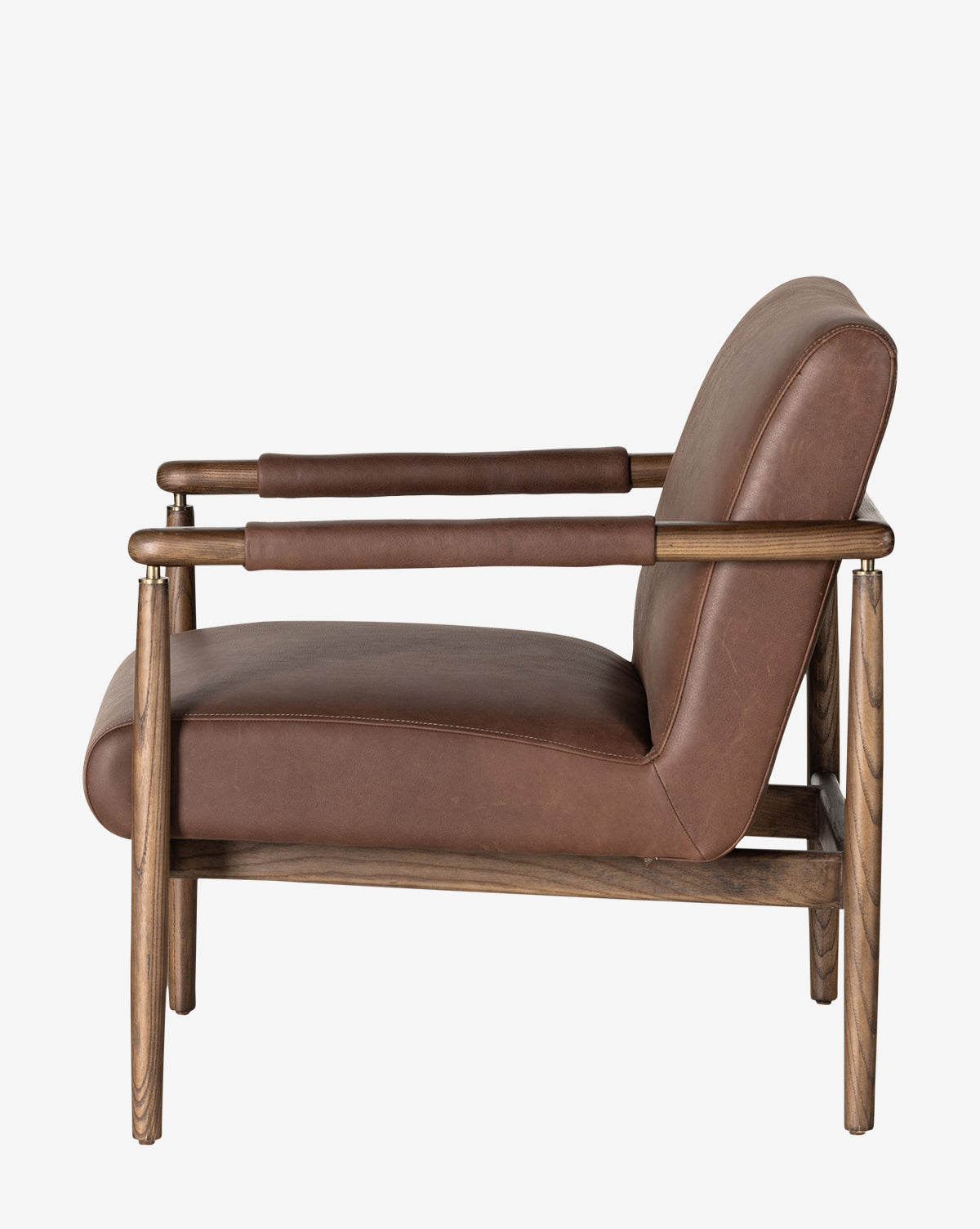 Side view of the Gaston Lounge Chair, with a solid ash frame and top grain leather cushions on the seat, backrest, and armrests, displayed against a plain white background by McGee & Co.