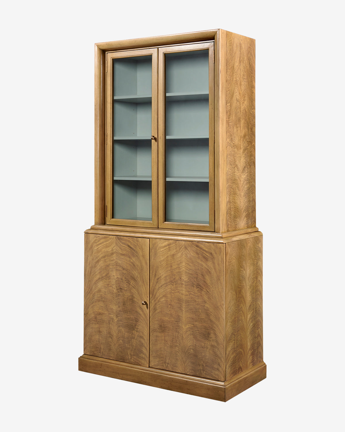 The Gethin Cabinet is a tall wood piece with a light brown finish, featuring glass-paneled double doors above for display with shelves, and solid lower doors for enclosed storage, by McGee & Co.