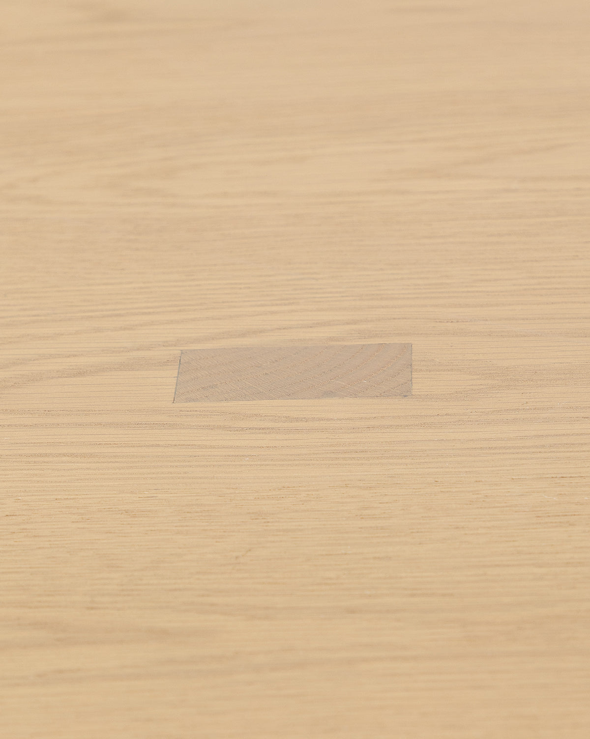 The Giselle Round Table features a light kiln-dried white oak surface, with a central area displaying a subtly different grain pattern and color for unique visual contrast, by McGee & Co.