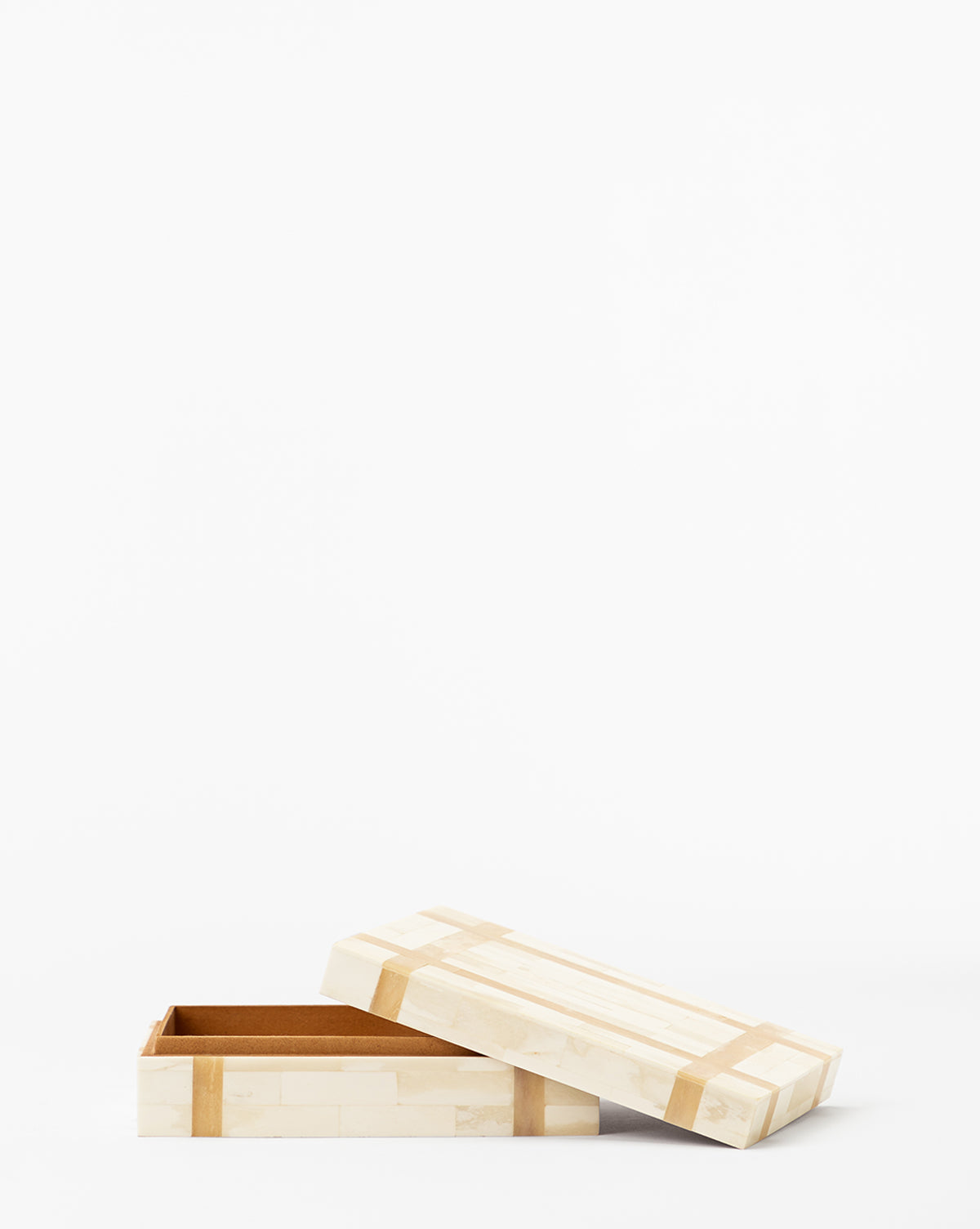 The Paige Bone Box is a rectangular storage box crafted from organic materials in a light color, shown with its lid partially open to reveal an empty interior, all set against a plain white background.