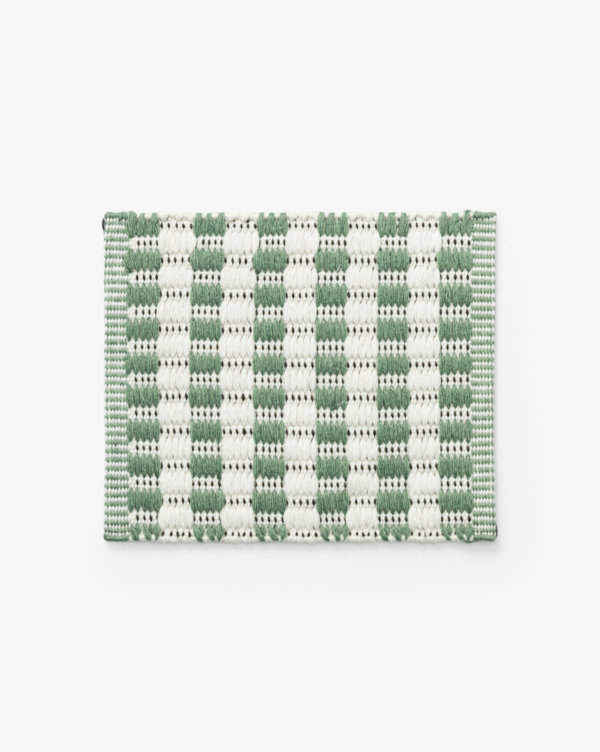 The Granada Green Indoor/Outdoor Rug Swatch is a rectangular, modern woven swatch with a green and white checkered pattern, handwoven for versatile indoor or outdoor use, shown on a plain white background by McGee & Co.