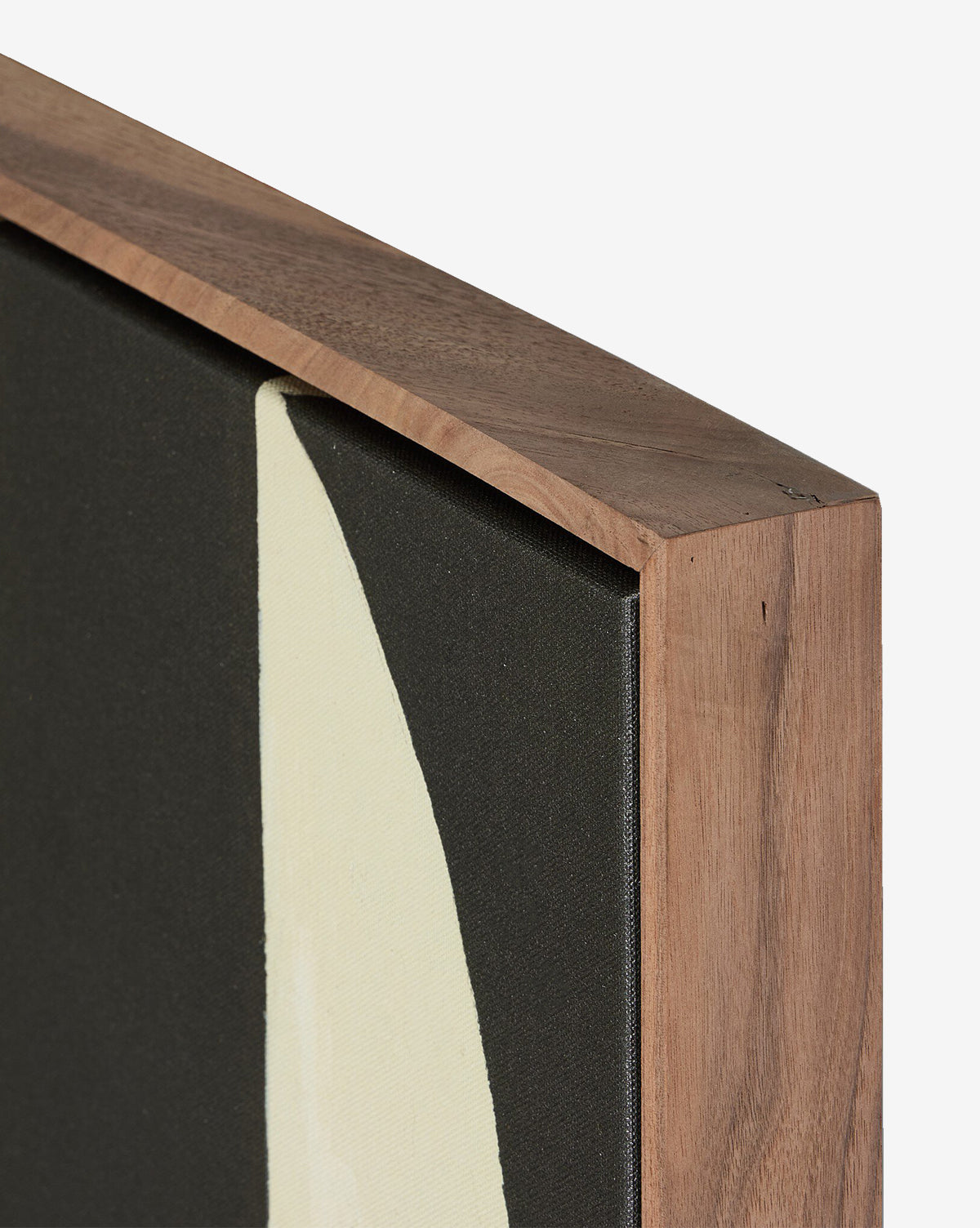 Close-up of the top corner of a walnut gallery floater frame around Grecco I by Jess Engle—a canvas featuring a cream abstract shape on black, perfect as a modern accent for any space, by McGee & Co.