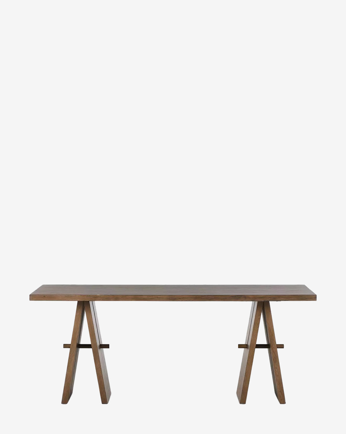 The Greenlaw Desk is a rectangular wooden farmhouse desk with a flat, spacious tabletop and two trestle-style legs, finished in rustic gray oak, shown against a plain white background by McGee & Co.