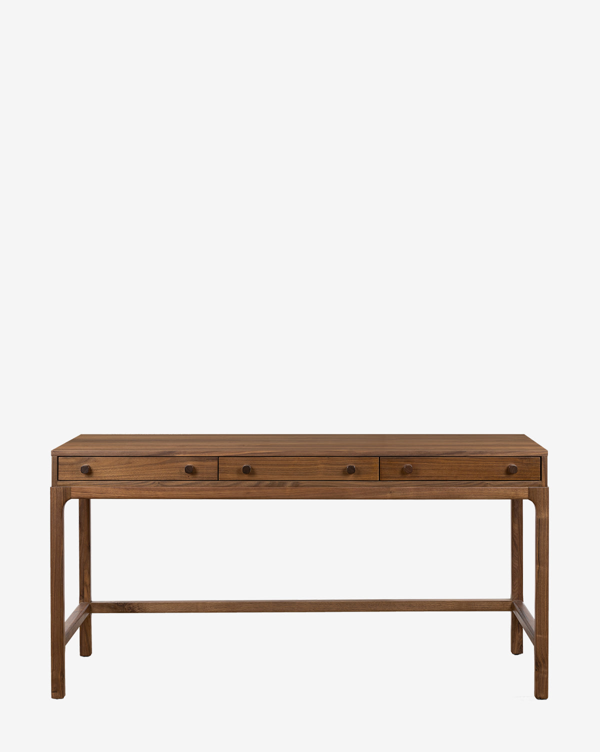 The Halliwell Desk features a simple, rectangular design made of solid walnut, with three drawers, round knobs, and four straight legs connected by support beams in a natural finish by McGee & Co.