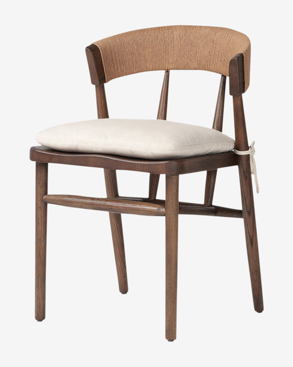 The Hallow Chair features a rustic design with a curved, woven backrest, beige seat cushion secured to the frame, and angled legs. Displayed against a plain white background by McGee & Co.