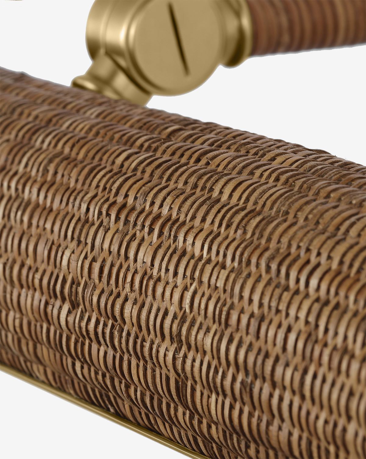 Close-up of the Halwell Picture Light, featuring a cylindrical design wrapped in tightly woven rattan, with a gold metal fixture partially visible in the background, by McGee & Co.