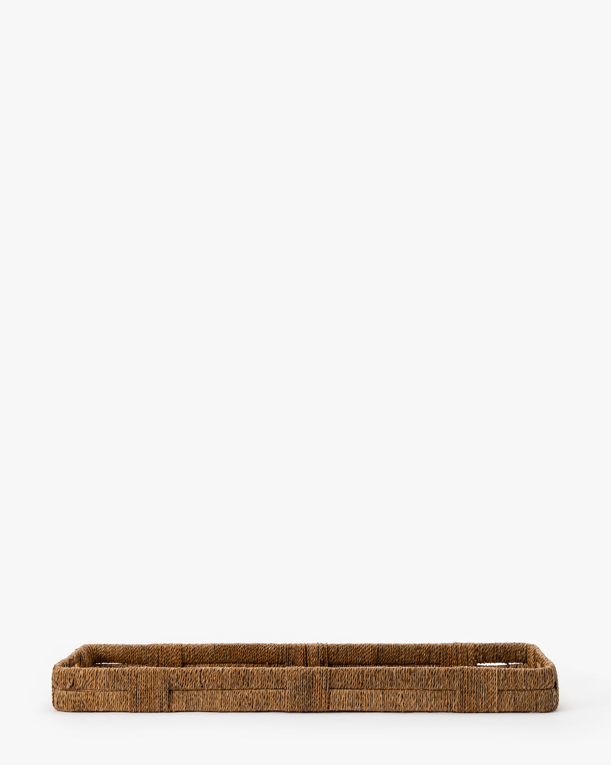 The Hand-Woven Bankuan Tray, made from natural fibers with rounded edges and a minimalist design, sits on a white background. Its natural texture makes it perfect as a decorative accent for any space.