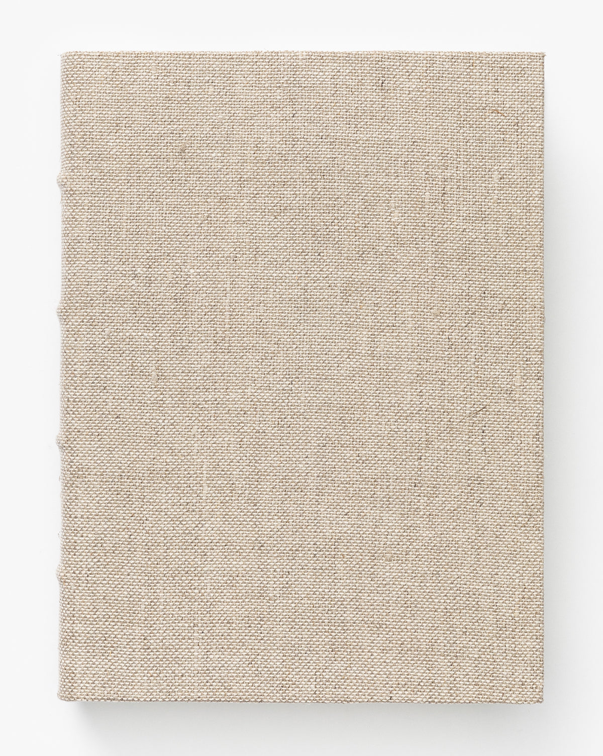 A closed Handcrafted Linen Book with a plain beige linen hardcover, shown from above on a white background. It features traditional binding and an unadorned cover with no visible text or images.