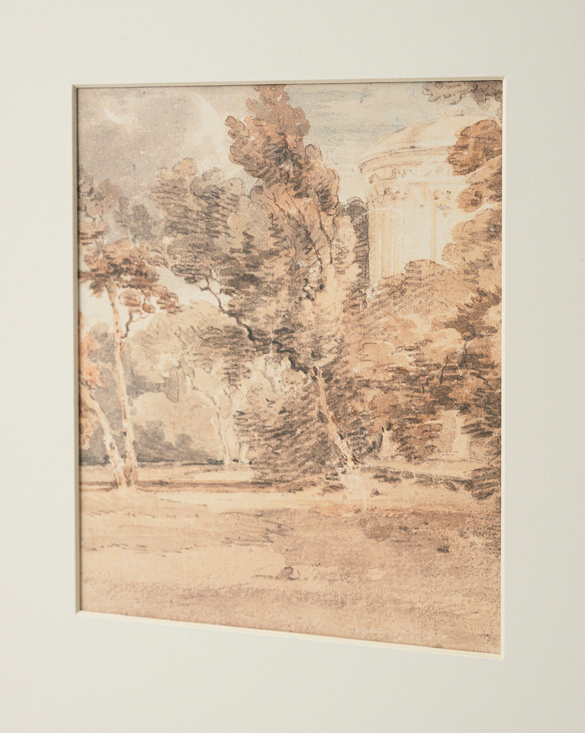 “Harewood Park” is a sepia watercolor scene of tall trees and foliage with a classical columned building in the background, beautifully reproduced as a giclee print and elegantly presented with a white mat, by McGee & Co.