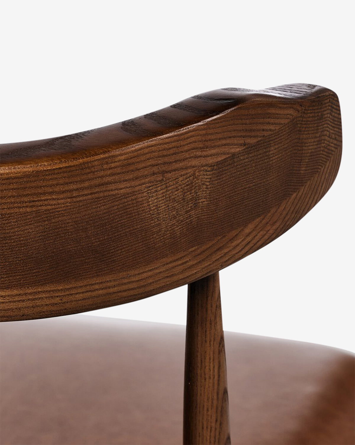 Close-up of the Harper Dining Chair’s curved solid ash backrest, highlighting its smooth polished finish and visible wood grain, by McGee & Co.