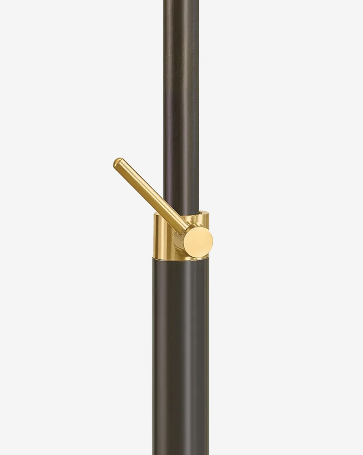 A close-up of the modern black and gold metal lever handle on the Harriet Floor Lamp, showcasing its minimalist design and adjustable lighting, set against a plain white background, by McGee & Co.