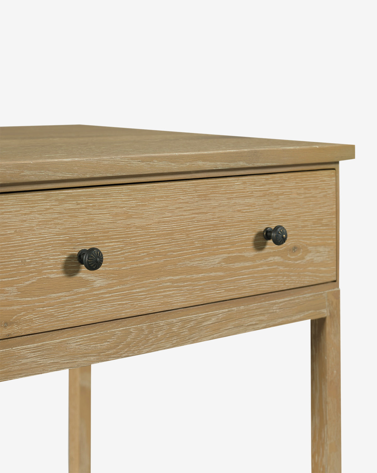A close-up of the Harrisburg Side Table in light wood, featuring a single drawer with two round black knobs, set against a plain white background by McGee & Co.