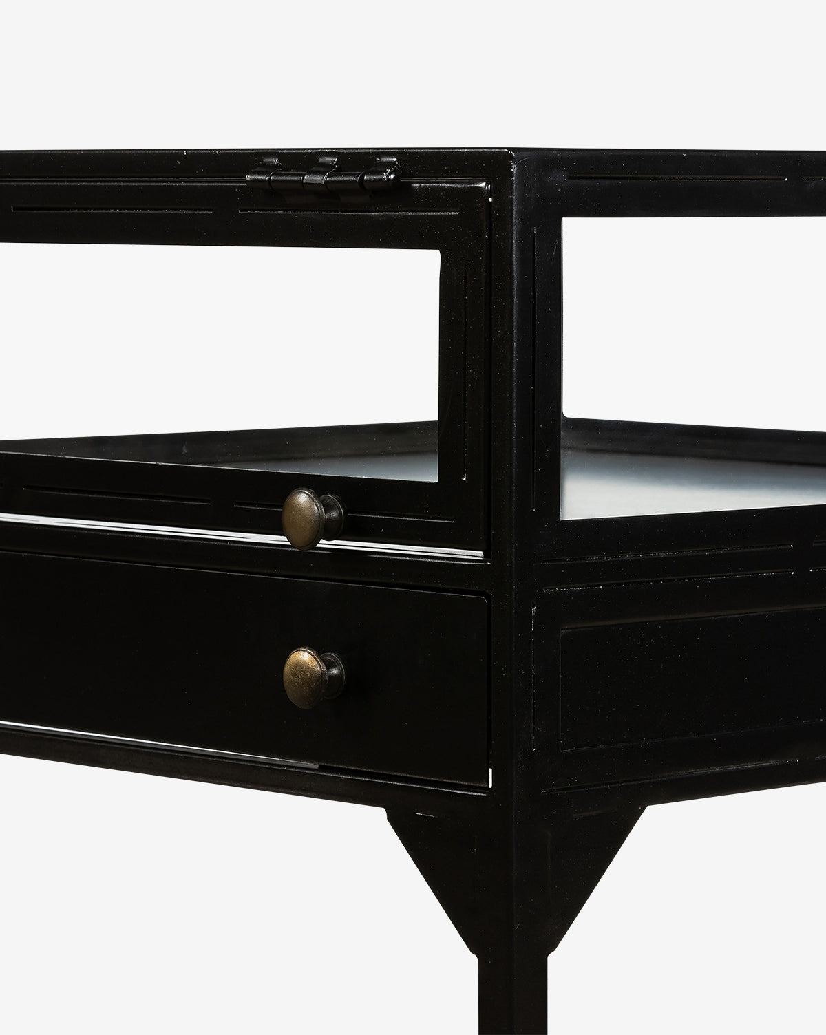 Close-up of the Harry Nightstand, featuring brass accents, glass panels, a drawer with two round brass knobs, and angular legs, set against a plain white background.