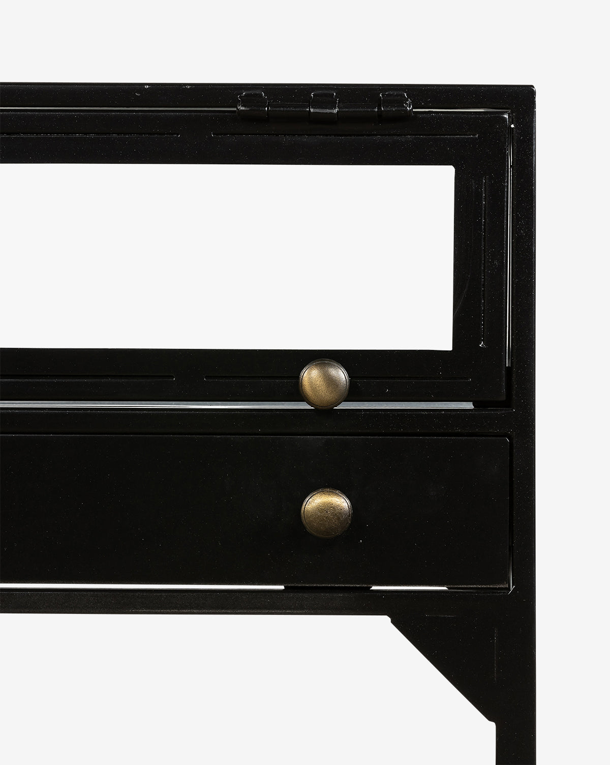 Close-up of the Harry Nightstand, featuring a black metal frame shadowbox design with two drawers, each with a round brass knob and an open rectangular cutout above the top drawer.