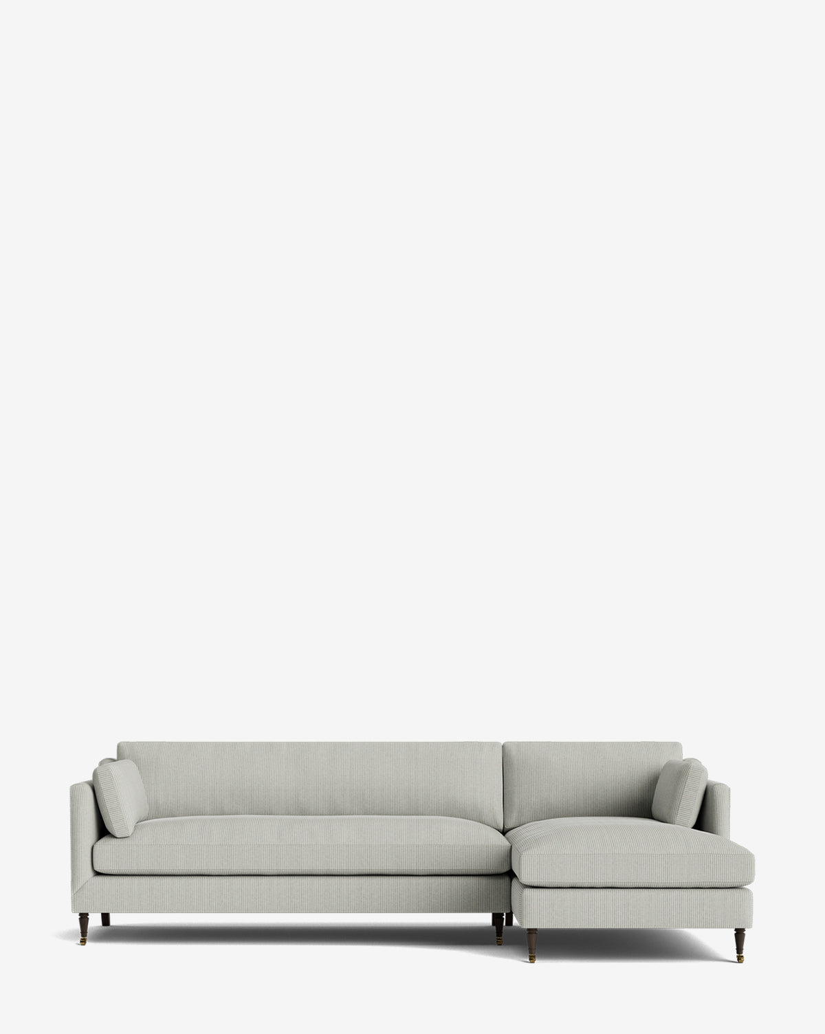 The Haverford Upholstered Right Chaise Sectional 113 is a light gray, made-to-order sectional with a right chaise, low backrest, slim armrests, and dark wood legs with brass tips, shown against a plain white background by McGee & Co.