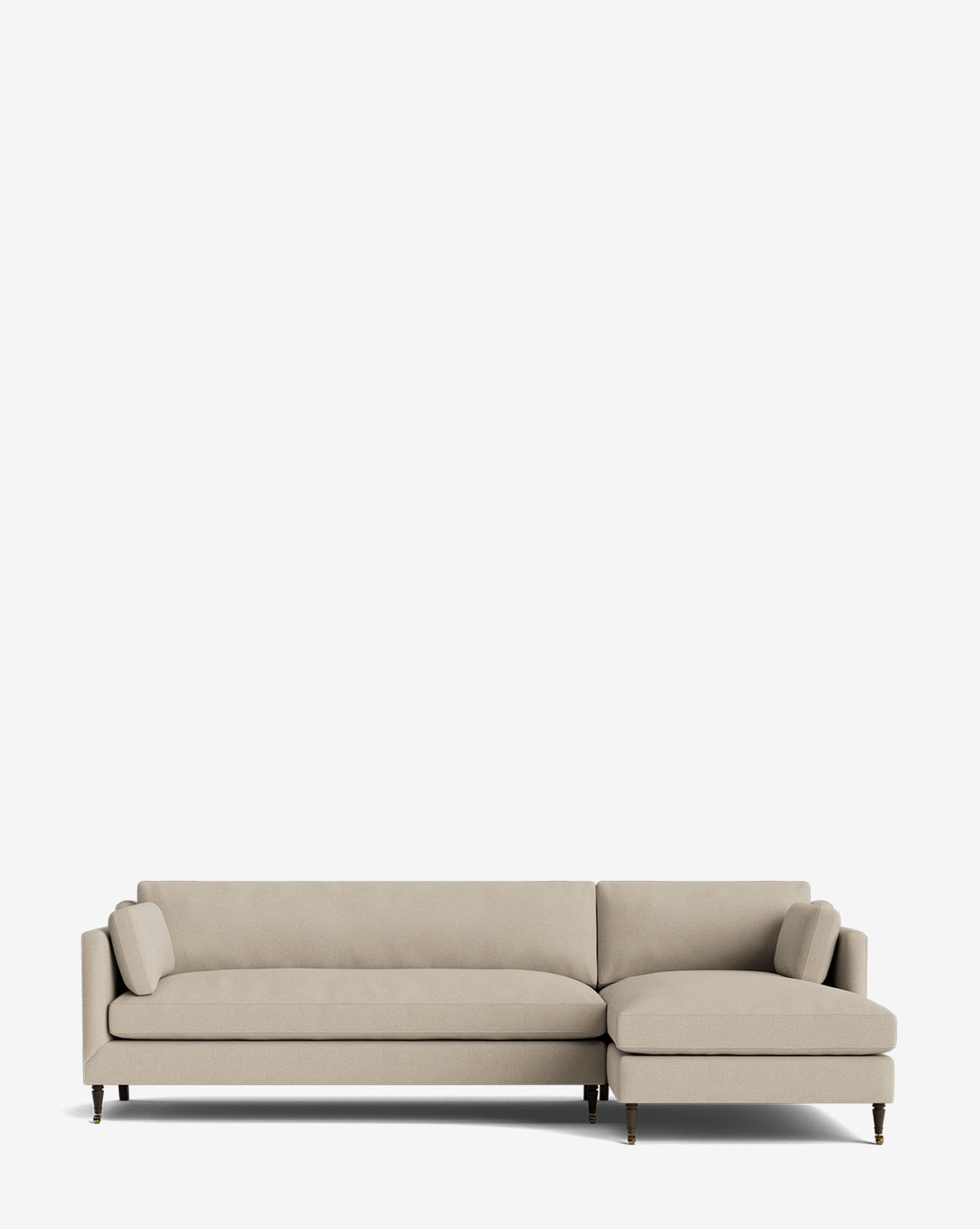 The Haverford Upholstered Right Chaise Sectional 113 in beige features clean lines, thin arms, dark wooden legs, a right-side chaise, and two matching bolster cushions against a plain white background by McGee & Co.