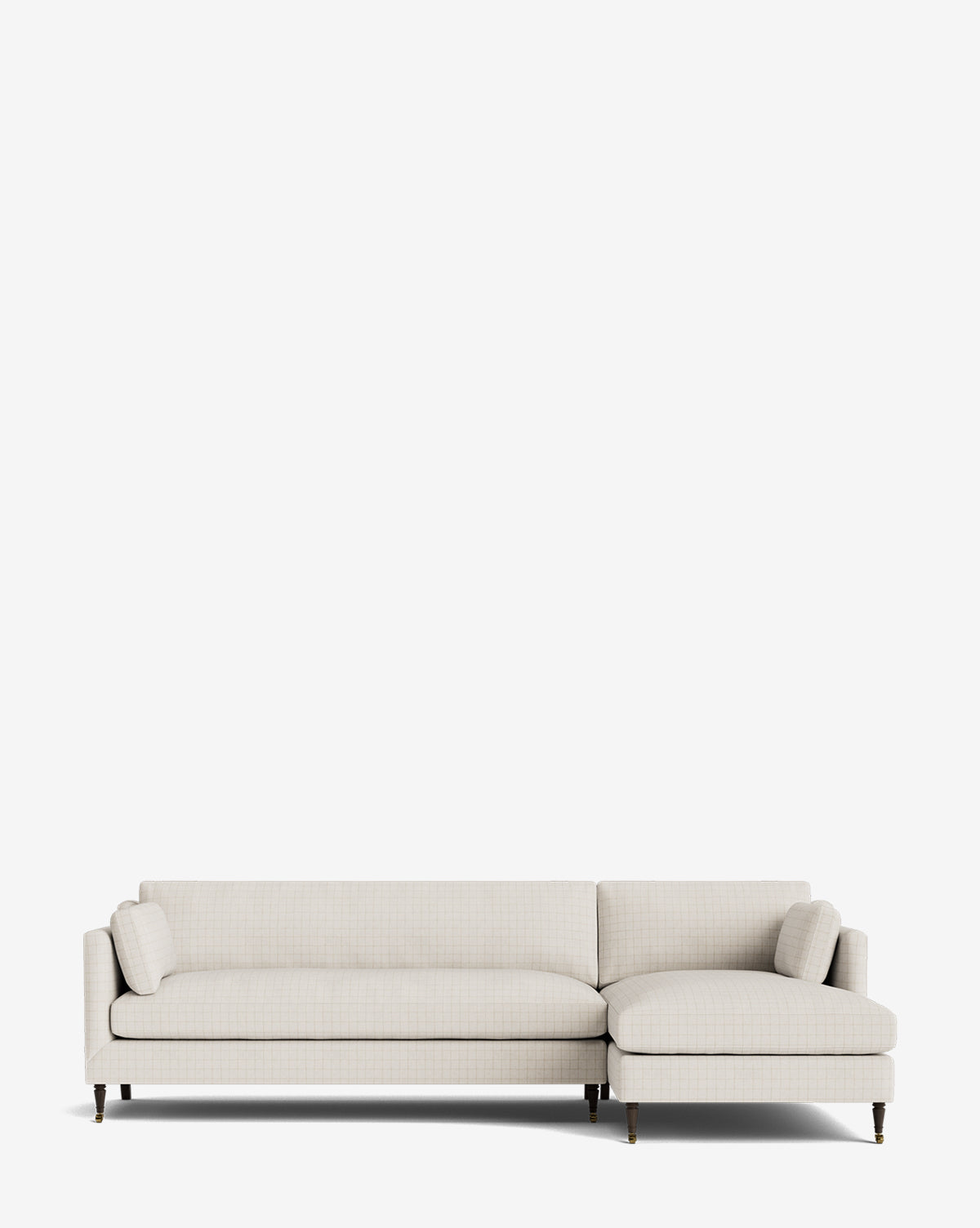 The Haverford Upholstered Right Chaise Sectional 113 is a modern, made-to-order light beige sectional with clean lines, low back, slim arms, tapered wooden legs, a right-facing chaise for lounging, and includes two matching cylindrical pillows by McGee & Co.