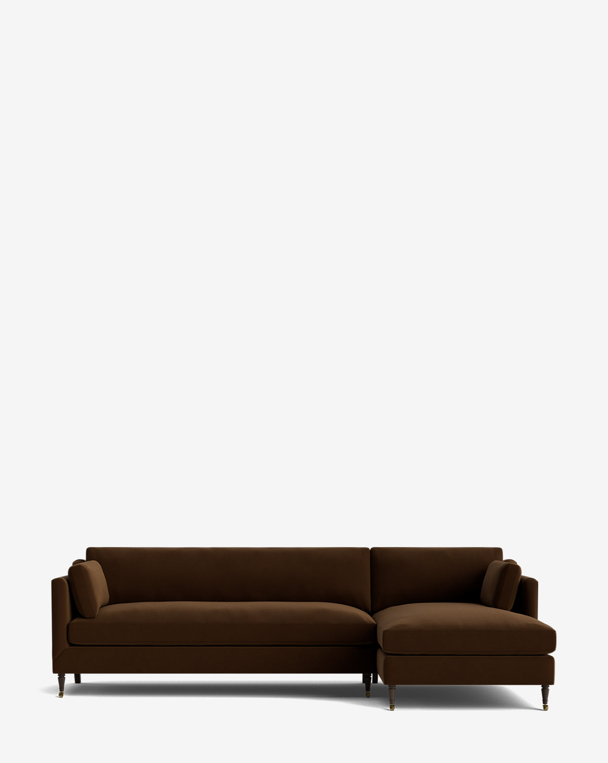 The Haverford Upholstered Right Chaise Sectional 113 is a modern, made-to-order dark brown sectional with slim legs and two cylindrical pillows, shown against a plain white background by McGee & Co.