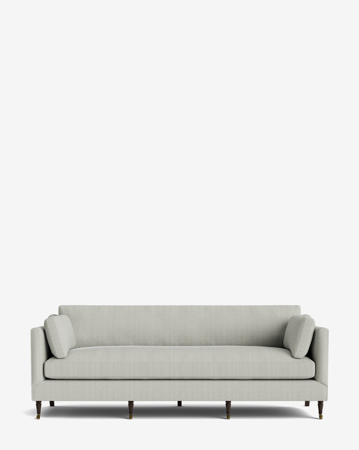The Haverford Upholstered Sofa 90 features a light gray, modern design with clean lines, matching cylindrical bolster pillows, and dark wooden legs with brass casters, all set against a plain white background for timeless style and comfort by McGee & Co.