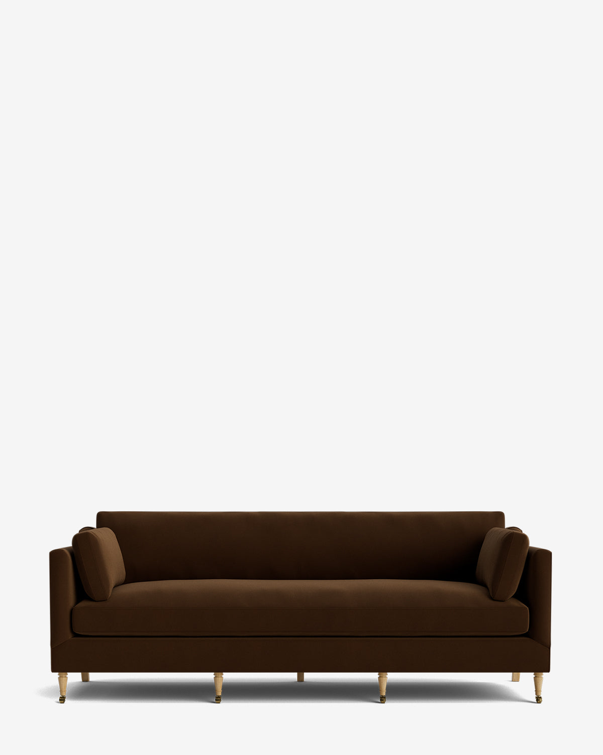The Haverford Upholstered Sofa 90 in brown velvet features straight arms, gold-colored legs, and two matching cylindrical cushions, creating a modern handcrafted look against a plain white background by McGee & Co.