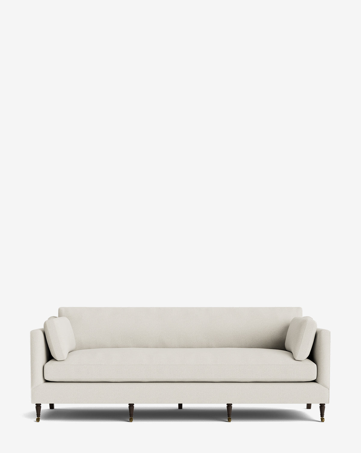 The Haverford Upholstered Sofa 90 is a modern light beige sofa with straight arms, dark wooden legs, and two matching bolster pillows, set against a plain white background by McGee & Co.