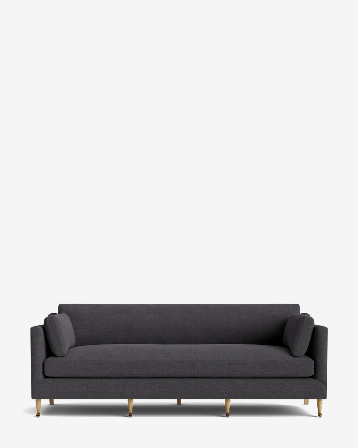 The Haverford Upholstered Sofa 90 features a modern dark gray design with two cylindrical cushions and slim gold legs, displayed against a plain white background, by McGee & Co.