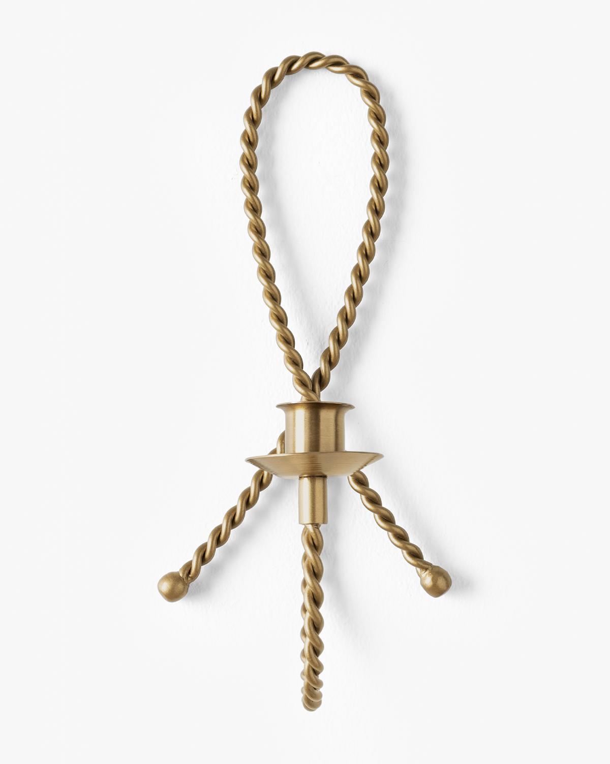 The Hearst Taper Holder is a sculptural brass candle holder featuring twisted, rope-like arms that loop at the top with two ends hanging down, all set against a white background, by McGee & Co.