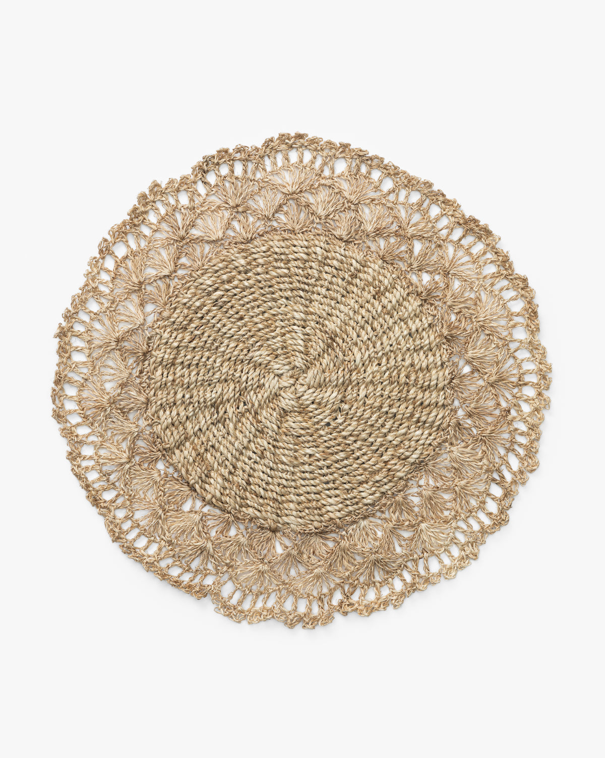 The Hermione Placemat features a round, woven design made of natural fibers with a braided center and crochet-inspired lacy edge, shown on a white background by McGee & Co.