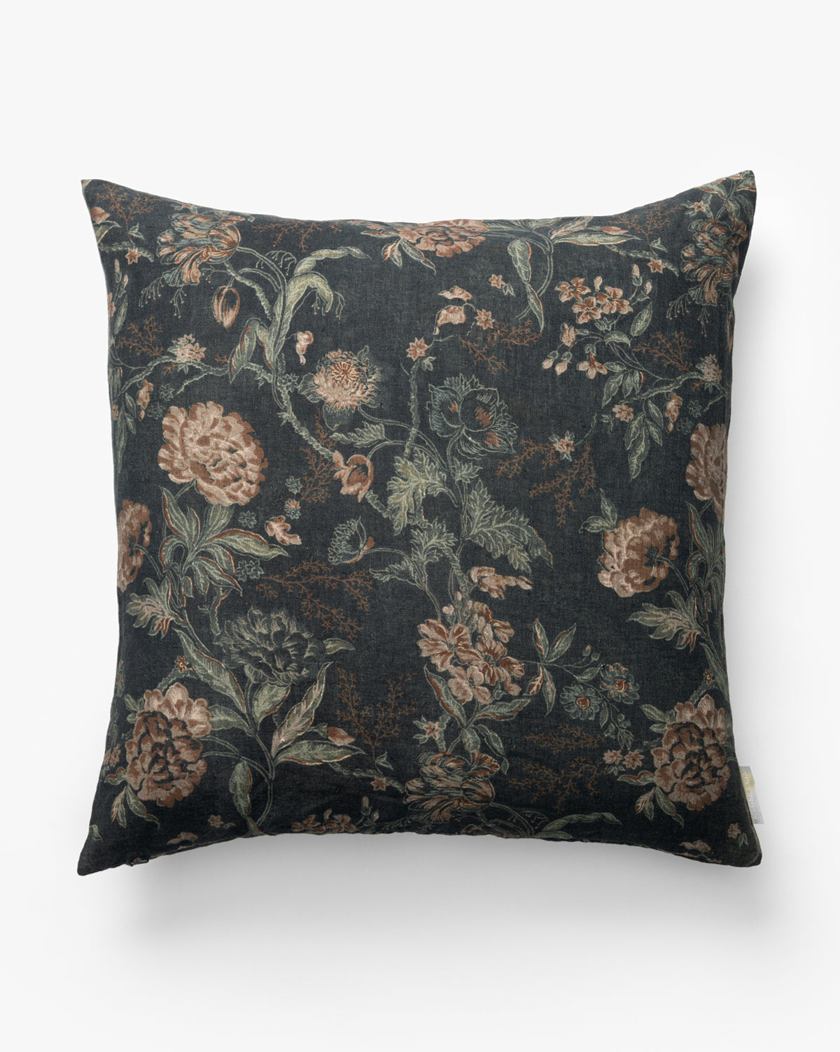 The Hestercombe Pillow Cover features a square design with a dark background and vintage-inspired floral pattern in muted green, brown, and beige tones, by McGee & Co. It’s shown photographed against a plain white surface.
