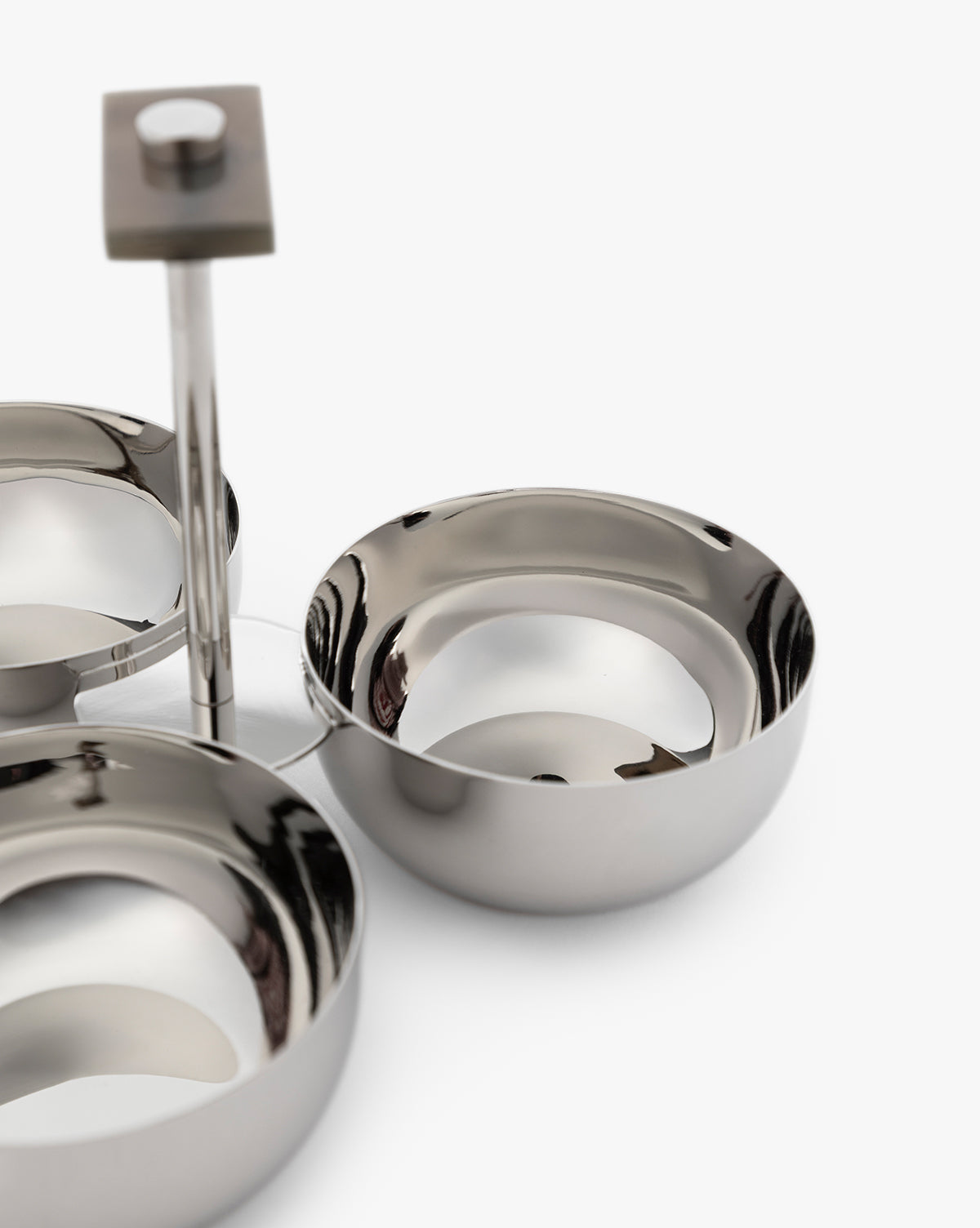 The Holland Condiment Set features shiny stainless steel bowls with a nickel polish on a sleek metal stand and a square horn-crafted handle, all photographed against a white background—ideal for adding modern style to your table, by McGee & Co.