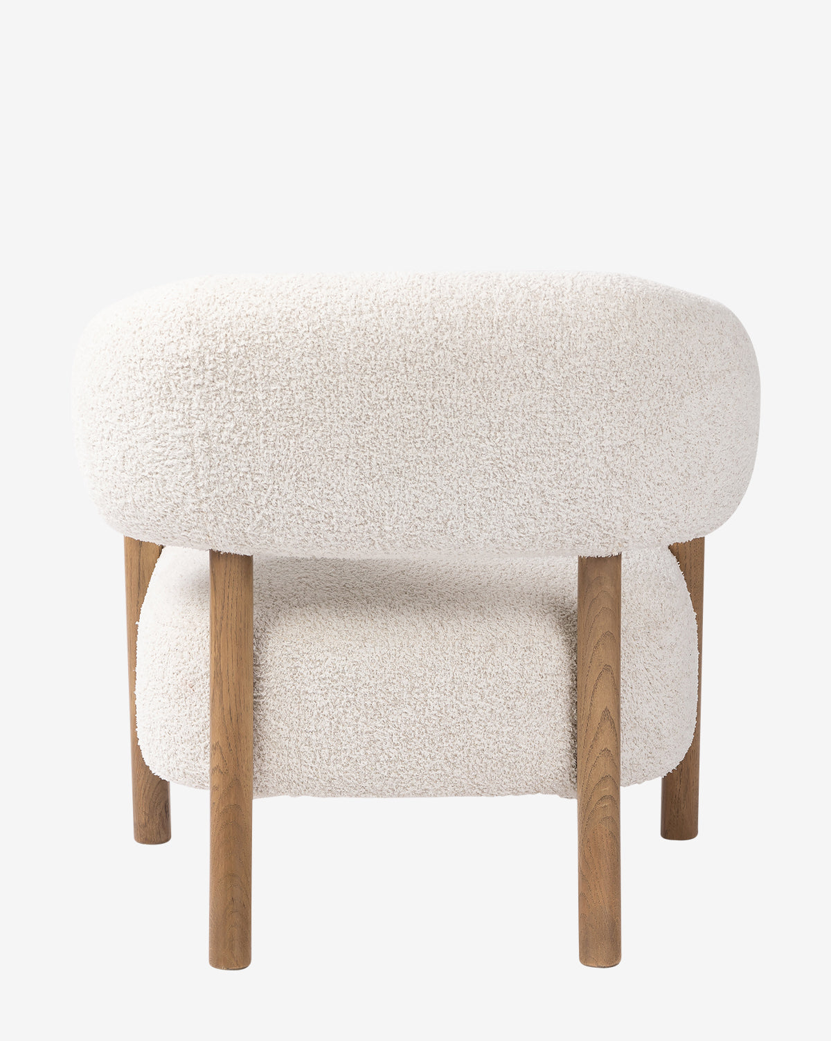The Holstein Lounge Chair features rounded, plush white faux Mongolian shearling upholstery and four straight solid oak legs, shown from the side against a plain white background by McGee & Co.