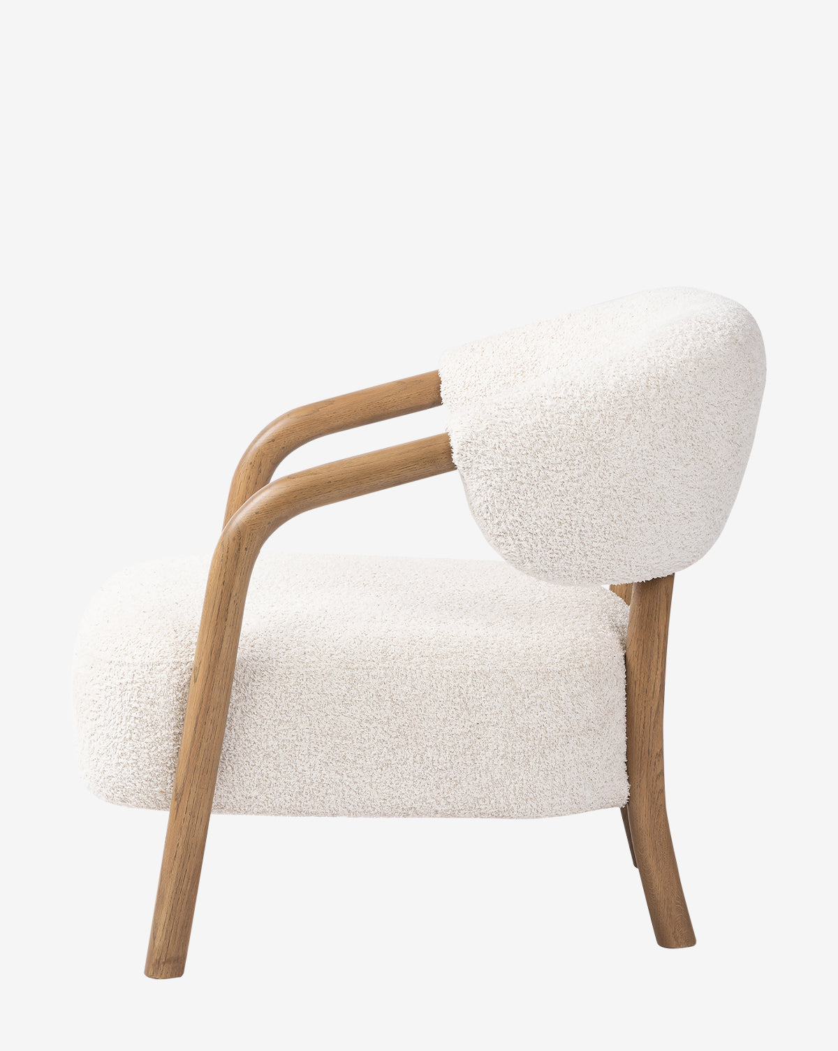 Side view of the Holstein Lounge Chair featuring a solid oak frame and plush white faux Mongolian shearling upholstery on the seat and backrest, set against a plain white background, by McGee & Co.