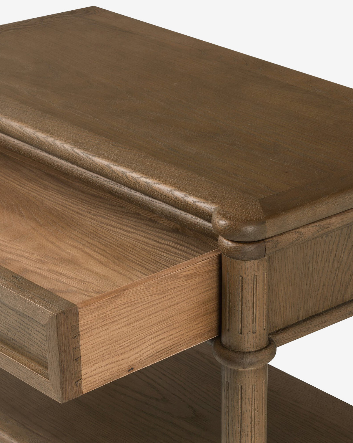 Close-up of the Humphrey Nightstand with an open drawer, revealing oak wood grain, rounded corners, carved side details, and a visible lower shelf—ideal for traditional bedroom decor, by McGee & Co.