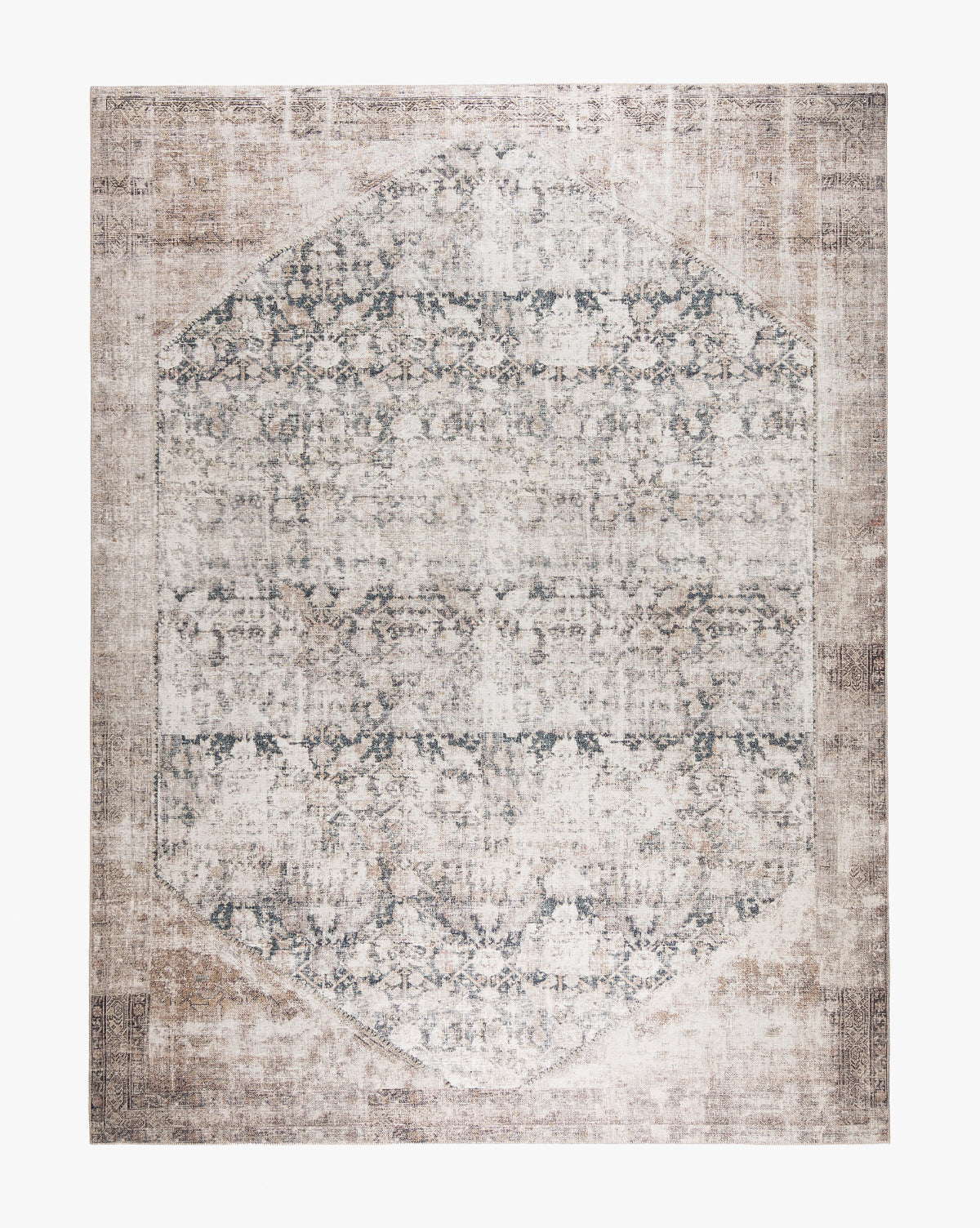 The Idalia Rug is a large area rug in neutral tones, featuring a faded vintage look with a central octagonal design, detailed floral motifs, and a distressed finish by McGee & Co.