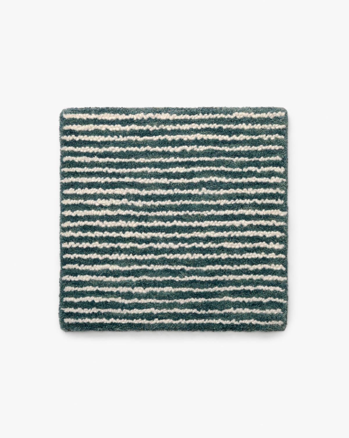 A square Inara Ocean Hand-Tufted Wool Rug Swatch features textured horizontal stripes in dark gray and off-white, shown on a plain white background by McGee & Co.
