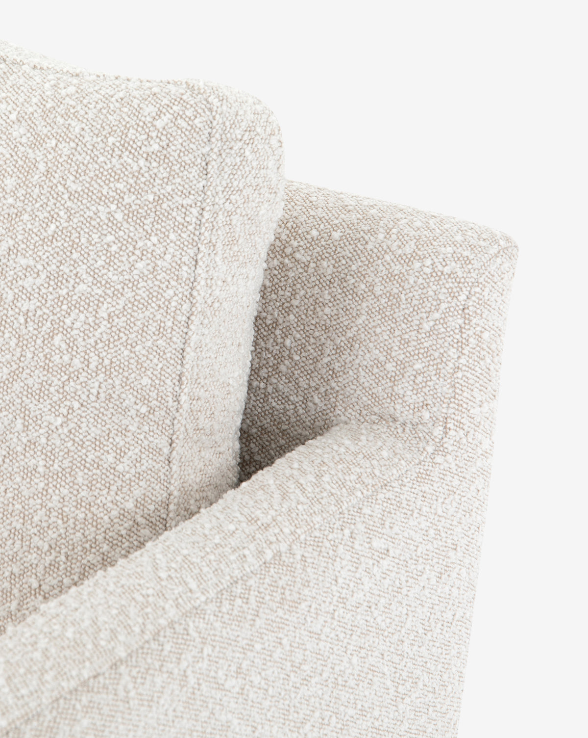 Close-up view of the Ivan Lounge Chair, a modern armchair with textured beige upholstered fabric and clean, angular cushion and armrest lines, set against a white background by McGee & Co.