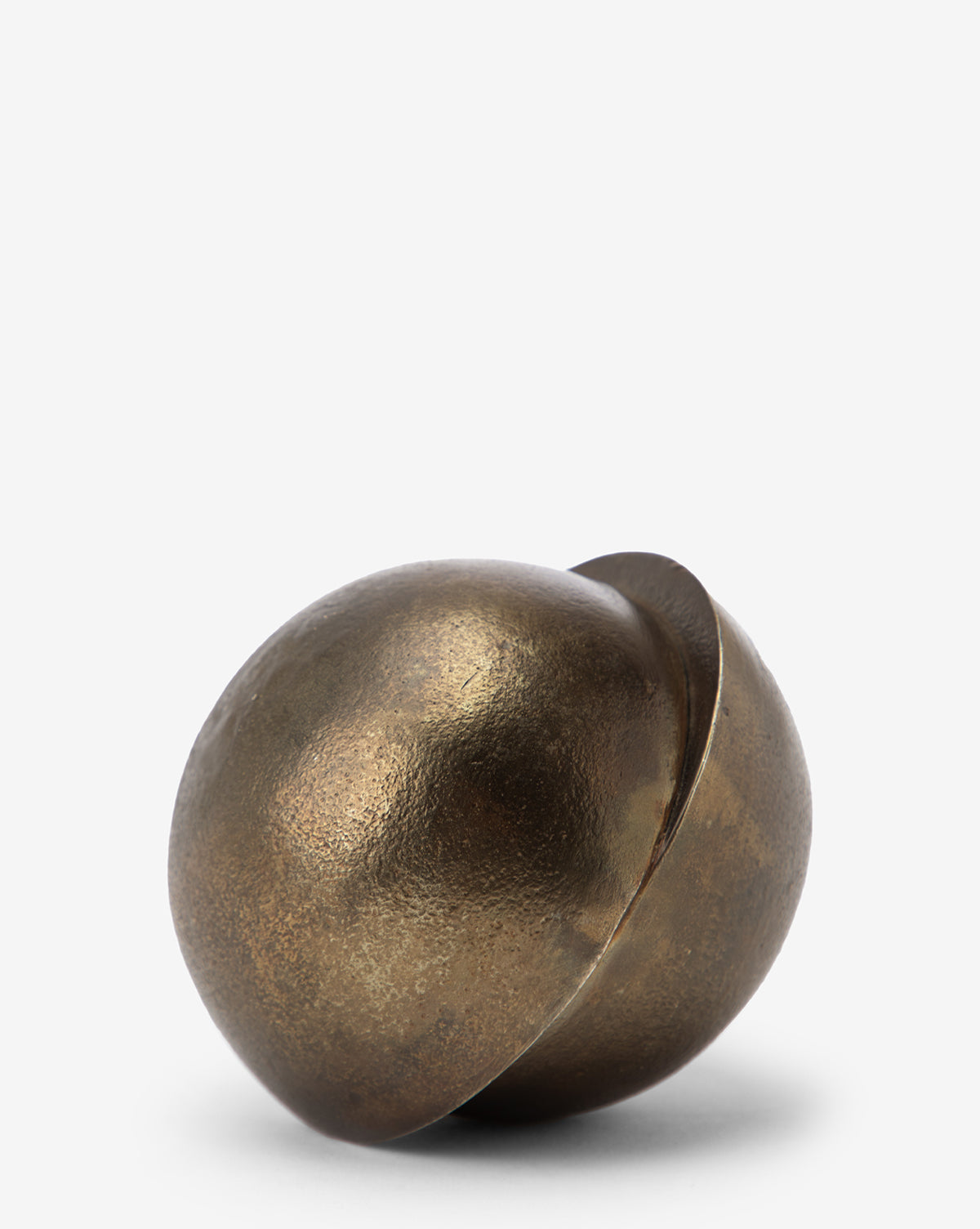 The Jackson Offset Sphere is a bronze, semi-spherical decorative object with a textured surface, modern detail, and an asymmetric split into two curved pieces resting together on a plain white background.