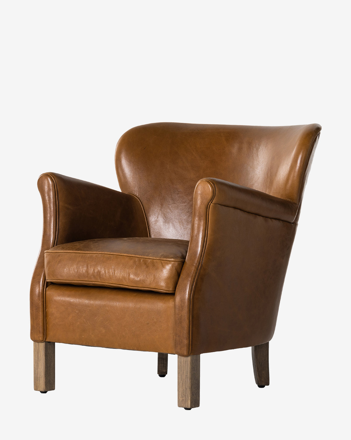 The Jarah Lounge Chair showcases curved arms and backrest, a cushioned seat, and wooden legs in rich brown top-grain leather upholstery, displayed against a plain white background by McGee & Co.