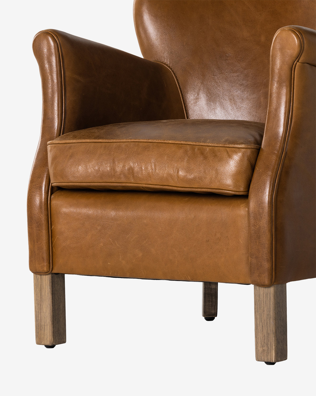 The Jarah Lounge Chair features brown top-grain leather upholstery, curved armrests, a cushioned seat, and wooden legs, displayed against a plain white background by McGee & Co.