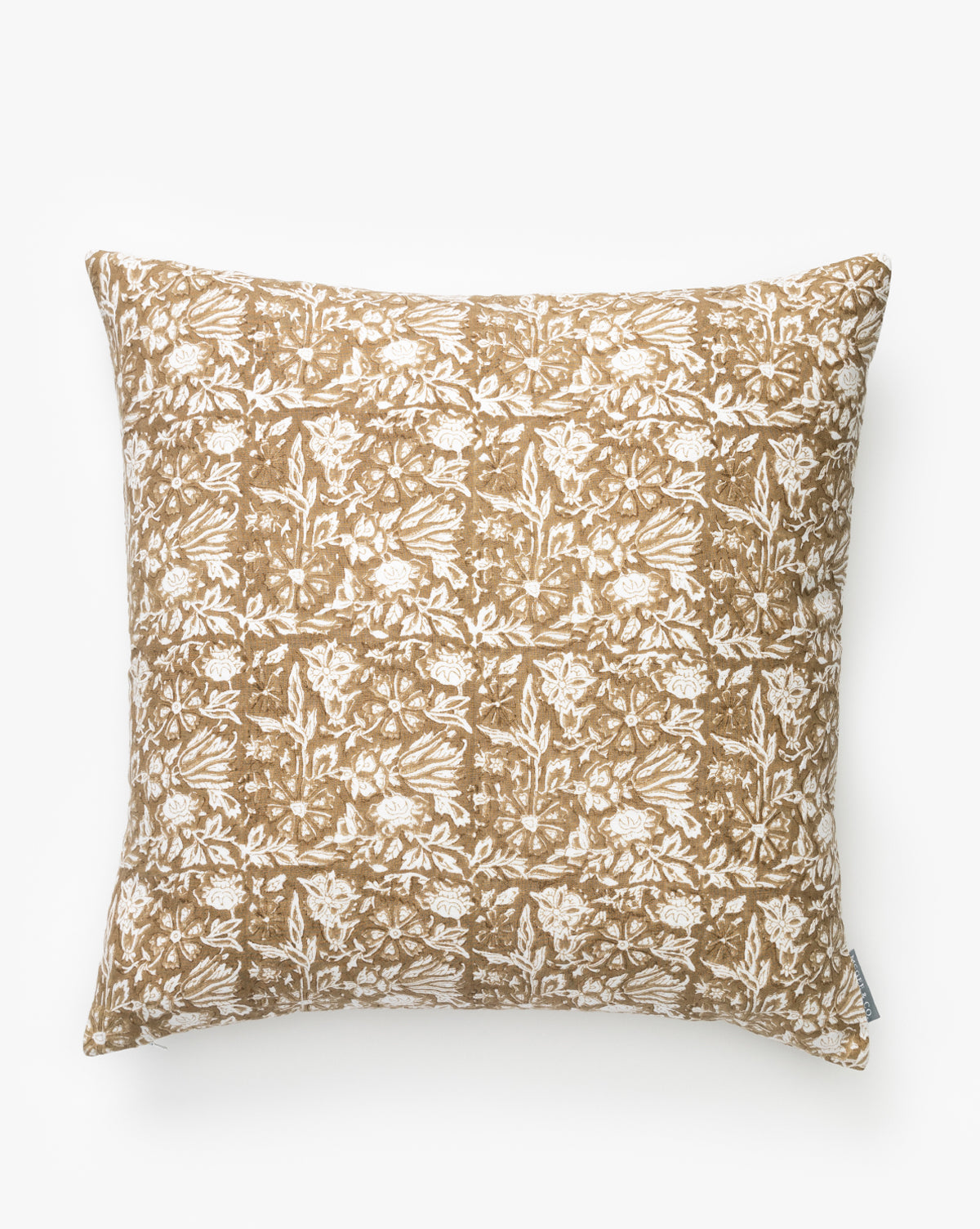 The Jentry Block Print Pillow Cover is a square pillow with a brown background and intricate white floral tile design, soft fabric texture, side tag, and classic block print style, by McGee & Co.